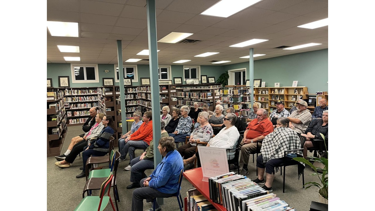 Community members gathered among the bookshelves at Thessalon Public Library